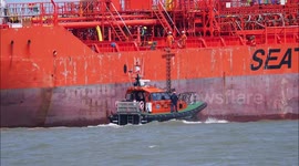 Thames pilots seen boarding and disembarking ships off Kent, UK