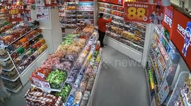 Woman startled by shopper while organizing shelf in Shandong, China