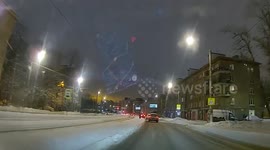 Pedestrian slips on ice and is nearly run over by car