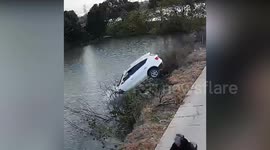 Pair rescued from SUV roof by OAP, 73, with boat after car shoots off