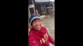 Worker has a beaming smile experiencing snow for the first time