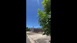 Children play in puddle on road in Paysandú, Uruguay