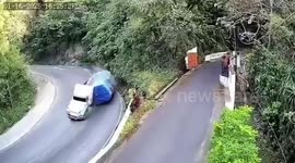Lorry loaded with maize overturns on sharp bend and crushes oncoming car