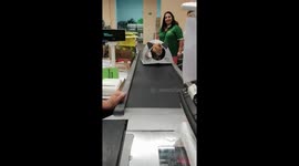 The cat rides inside his new house on the tape in the store!