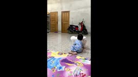 The little boy loves to play with the big white cat!