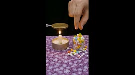 Green Foam Bead Melts Over Candle Flame