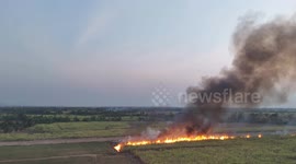 A scene from hell as sugar cane  leaves are burned as part of harvesting.