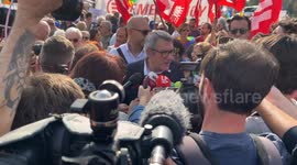 Maurizio Landini, secretary of the CGIL union, speaks to journalists, surrounded by microphones, on the occasion of the national day of mobilization for peace with the motto ‘Let's stop the wars, the time for Peace is now’ in Rome.