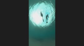 Couple perform beautiful underwater freediving dance
