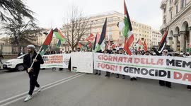 Protesters wave Palestinian and Lebanese flags behind the banner reading ‘Remembrance Day, Genocide Out of History’ during Palestine Support Rally ahead of Remembrance Day in Rome.