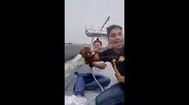 Fishermen fall into water while sitting on speeding boat