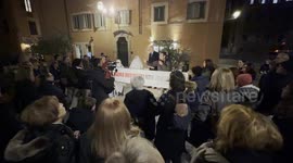 Two protesters dressed as ghosts behind the banner with the slogan ‘we are residents not ghosts’ displayed during the speeches during the protest against the unlivability of some areas of the historic center, due to mass tourism, in Rome.