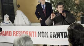 Two protesters dressed as ghosts behind the banner with the slogan ‘we are residents not ghosts’ displayed during the speeches during the protest against the unlivability of some areas of the historic center, due to mass tourism, in Rome.