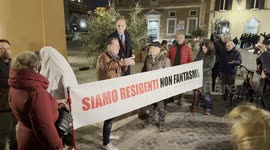 A protester dressed as ghost behind the banner with the slogan ‘we are residents not ghosts’ displayed during the speeches during the protest against the unlivability of some areas of the historic center, due to mass tourism, in Rome.