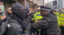 'Under what law!!': Protesters push back after an arrest was made as around a thousand reject plans for a new Chinese embassy at Tower Hill