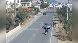 China: Driver Distracted by Phone Slams Into Cyclist, Crashes Through Wall