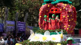 Hundreds of Coca - Cola cans decorate a strawberry float in Thailand's Strawberry Festival