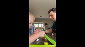 Competitive toddler disrupts dad's tower building fun with toy car rampage