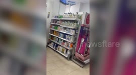 Video shows brazen shoplifter stuffing goods into bag at UK pharmacy.