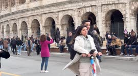 Tourists in the square in front of the Colosseum in Rome.