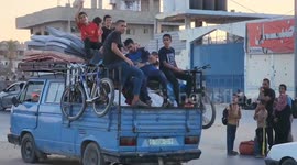 Displaced Palestinians wait for aid amid the rubble of Gaza’s destruction