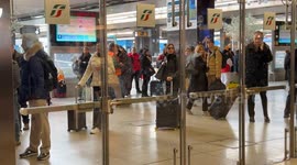 Travelers wait for a train to arrive on a day when the arrival board shows heavy delays of up to 3 hours at Termini Station in Rome