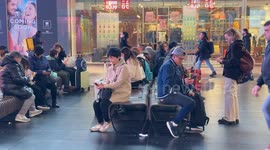 Travelers in the waiting zone on a day when the incoming train board shows heavy delays of up to more than 3 hours at Termini Station in Rome.