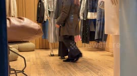 Legs of people walking inside one of the luxury clothing stores on Via Condotti in Rome.