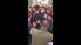 Hundreds of young people rush to grab the wooden ball in the unique 