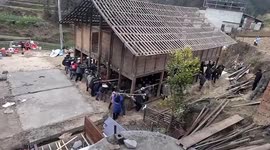 Heartwarming moment villagers carry home to new plot in China