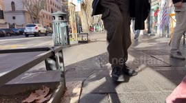 A keybox, one of the symbols of overtourism, hanging from a fence bar of a tree in Rome.