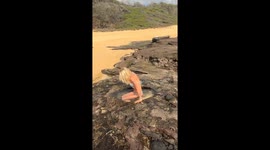 Woman decides to take a dip in a nature made pool, but then a fish leaps out onto land
