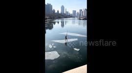 Topless pensioner rides floating ice chunk in China - even performs headstand and splits