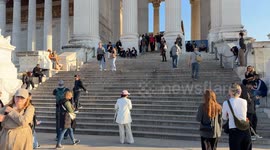 Tourists visit the Altar of the Fatherland on a beautiful sunny day in February in Rome.