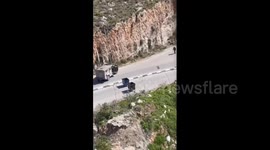 Israeli soldiers aim their rifles at a Palestinian man during their incursion into the northern areas of Nablus