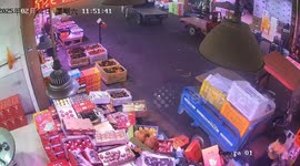 Youngster riding a fruit cart crashes into shop