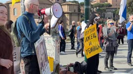 A protester dressed as Death holds up a sign with the Cyrillic slogan 'Putin is a liar and a murderer' during the sit-in to demonstrate against the “Putin regime” and to promote the “Energy For Life” campaign by some Russian dissidents in Rome.