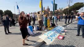 A protester shouts the slogan 'Putin assassin' with a megaphone (in Italian and Russian) during the sit-in to demonstrate against the “Putin regime” and to promote the “Energy For Life” campaign by some Russian dissidents in Rome.