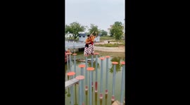 Lion dancers practice pole jumping over river in China