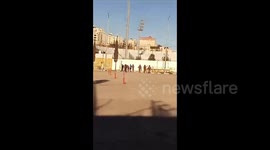 Israeli soldiers raid a schoolyard during the ongoing offensive in the town of Dura
