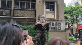 Cat spotted resting on top of statue in Guangzhou, China