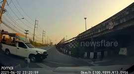 Bungling truck driver misjudges the height of his trailer and crashes into low bridge