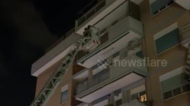 The Fire Department's crane with the basket carries some firefighters to a balcony to force open the window of an apartment where a person is locked inside alone who has fallen ill in a peripheral area of ​​Rome.