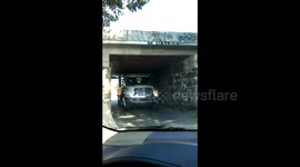 Driver gets angry at truck stuck under bridge