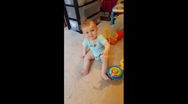Baby cries as a piece of vinyl gets stuck to his fingers
