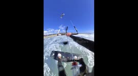 Kiteboarder Flies Beneath Windsurfer
