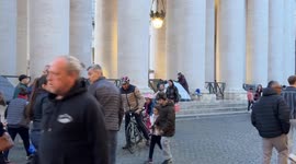 An elderly homeless woman sets up her tent among the other tents already erected under Bernini's colonnade where she will spend the night in St. Peter's Square in Vatican City in Rome.