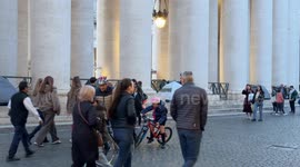 An elderly homeless woman sets up her tent among the other tents already erected under Bernini's colonnade where she will spend the night in St. Peter's Square in Vatican City in Rome.