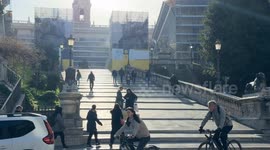 The climb of the Campidoglio and zoom out as two horse-drawn botticelle pass by on a sunny morning at the end of February in Rome.