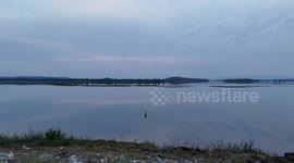 A lucky fish makes a last moment dash for freedom and escapes from the hand of a fisherman at nam Un Dam, Thailand.